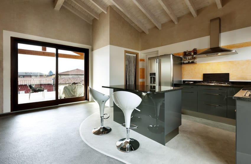 High ceiling kitchen with colored concrete flooring