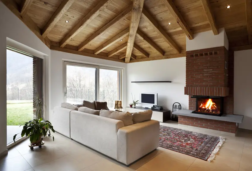 High wood ceiling in living room with fireplace