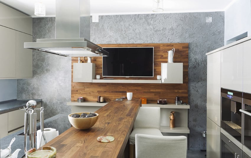 Kitchen with plain white walls, grey accent wall with modular cabinets