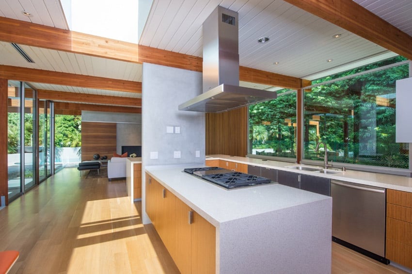 Kitchen with view of garden and wood cabinets with white counters