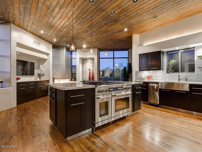 Kitchen with wood ceiling and wood floors and large center island