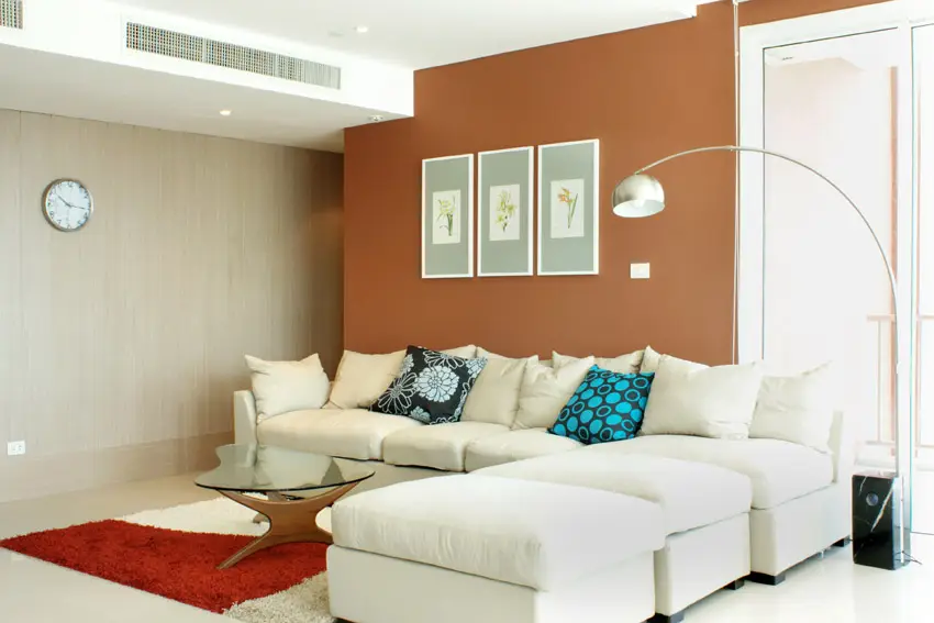 Living room with tan and burnt orange accent walls