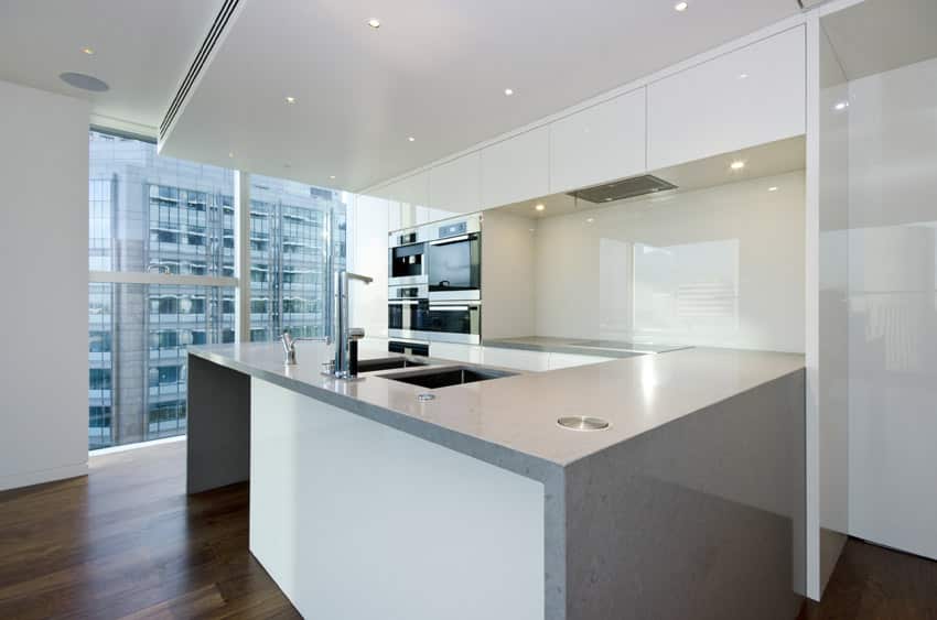 Kitchen with U-shape design with light grey countertop and full storage cabinets