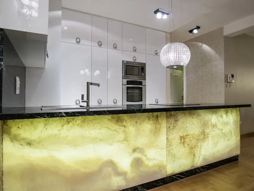 Kitchen with custom yellow black island and globe chandelier