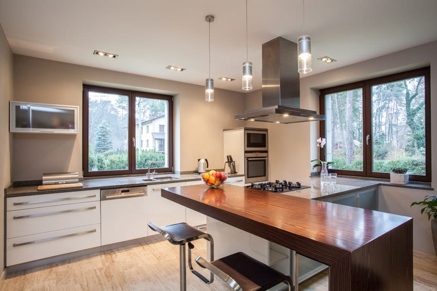 Kitchen with lone overhead cabinet, recessed lighting and ledge with cherry wood finish