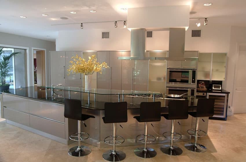 Modern kitchen with long dining island and chrome and leather bar stools