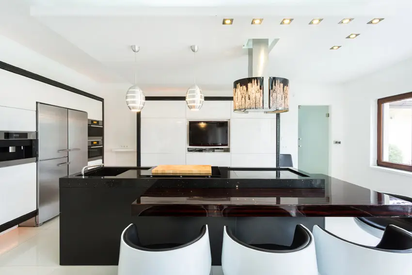 Kitchen with retro seating, full height cabinets and matte black counters