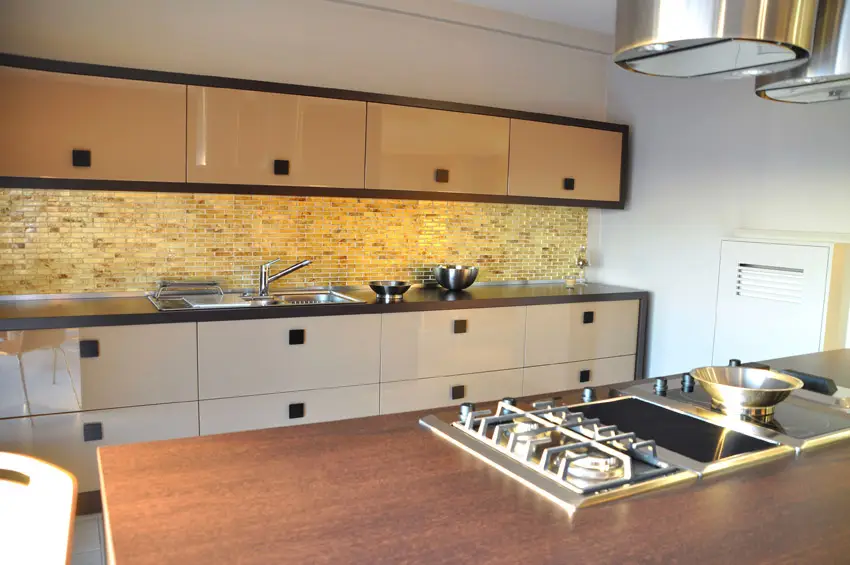Modern kitchen with tile backsplash and wood topped island