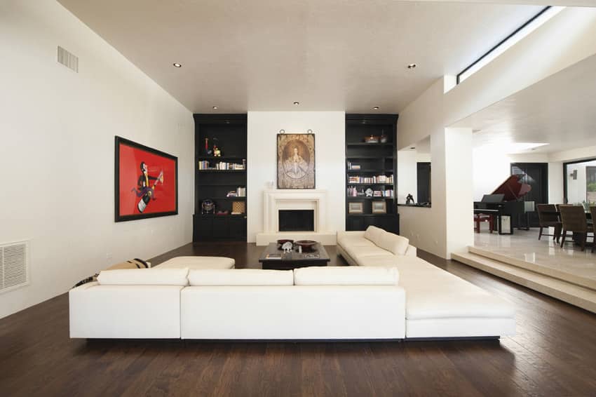 Modern white themed living room with black built-in-shelving