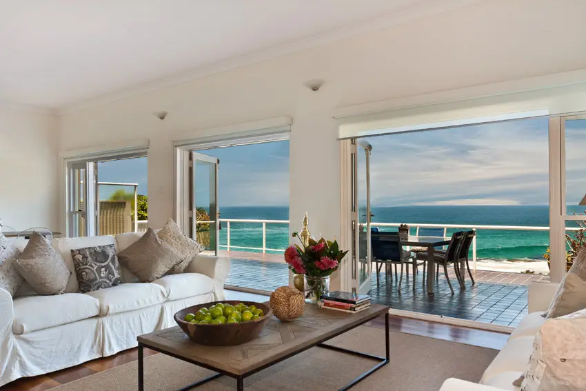 Oceanfront living room with wood flooring and view of water