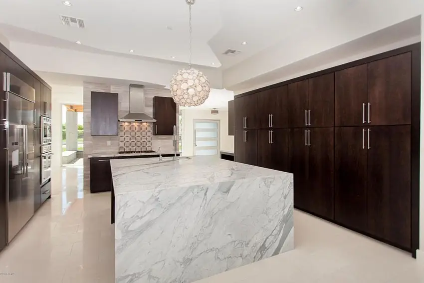 Stylish modern kitchen with round wire ball light and dark cabinetry