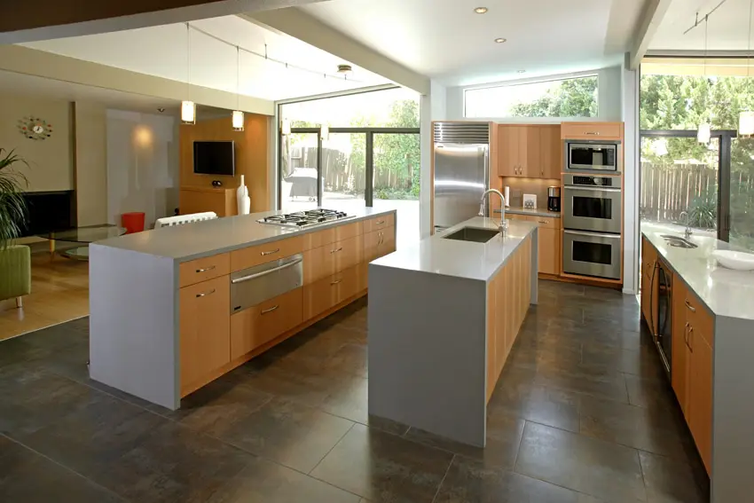 Open plan layout kitchen with laminated pinewoood cabinets and black ceramic flooring