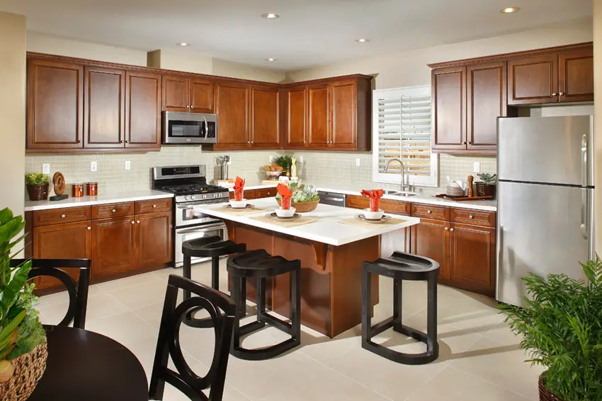 Kitchen island surrounded by cherrywood cabinetry