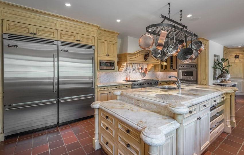 White marble counters, double door refrigerators and ash wood type cabinets