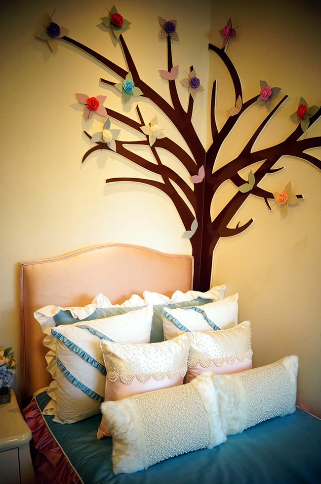 Bedroom with wall art of tree