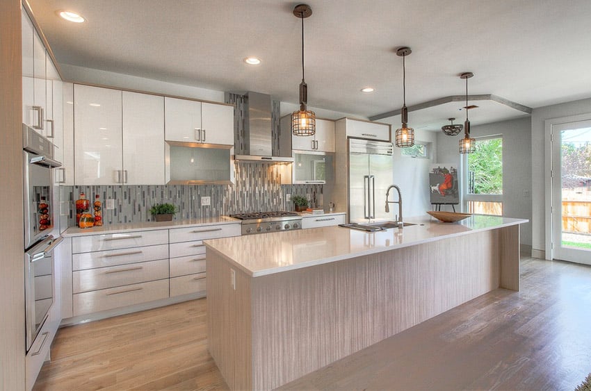 Contemporary kitchen with glass backsplash, pendant lighting and light color cabinets
