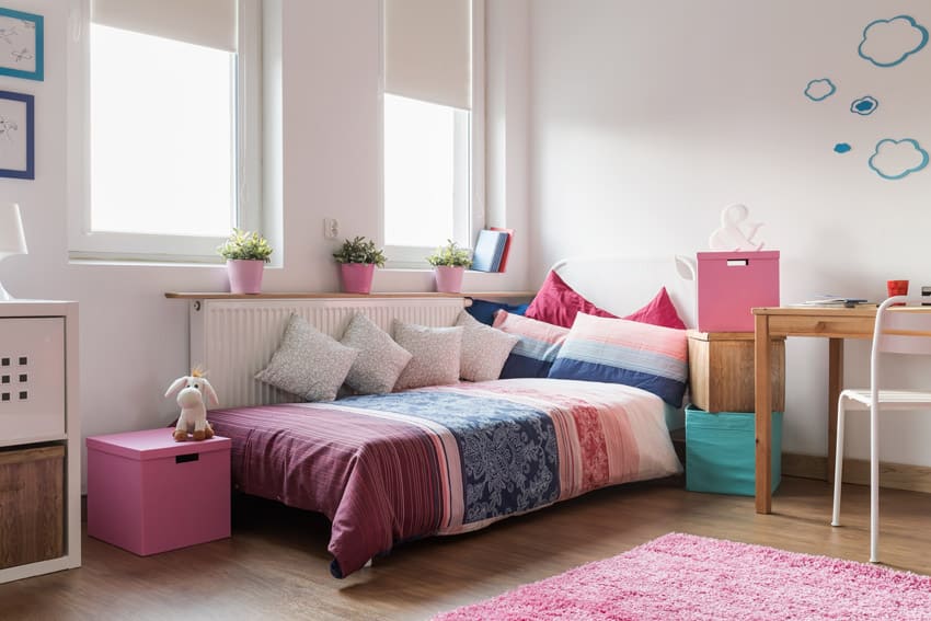 Day bed in girls room with wood floors and desk