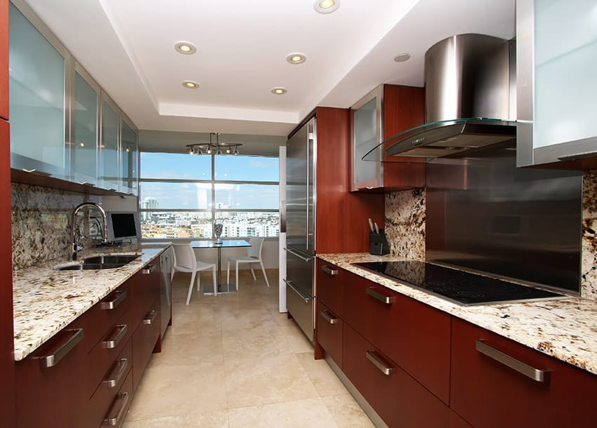 Galley kitchen with matching granite counter and backsplash