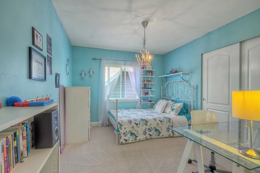 Girls bedroom with chandelier and blue painted walls