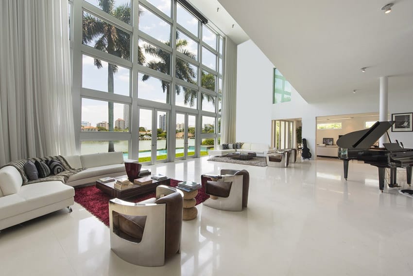 Large modern living room design with high ceilings, water view and grand piano