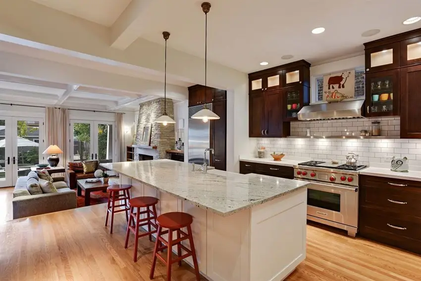 Kitchen with three red stools and backsplash