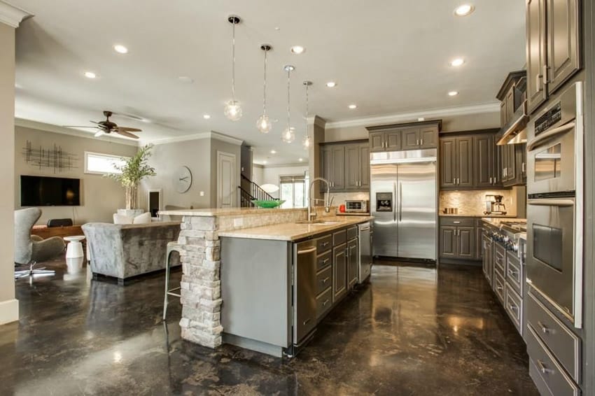 Kitchen with stone counter bi-level island with built in sink