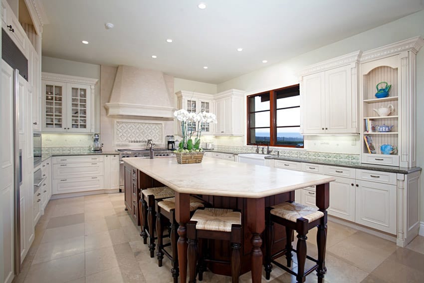 Kitchen with white cabinets and different color island with dark cabinets and white marble