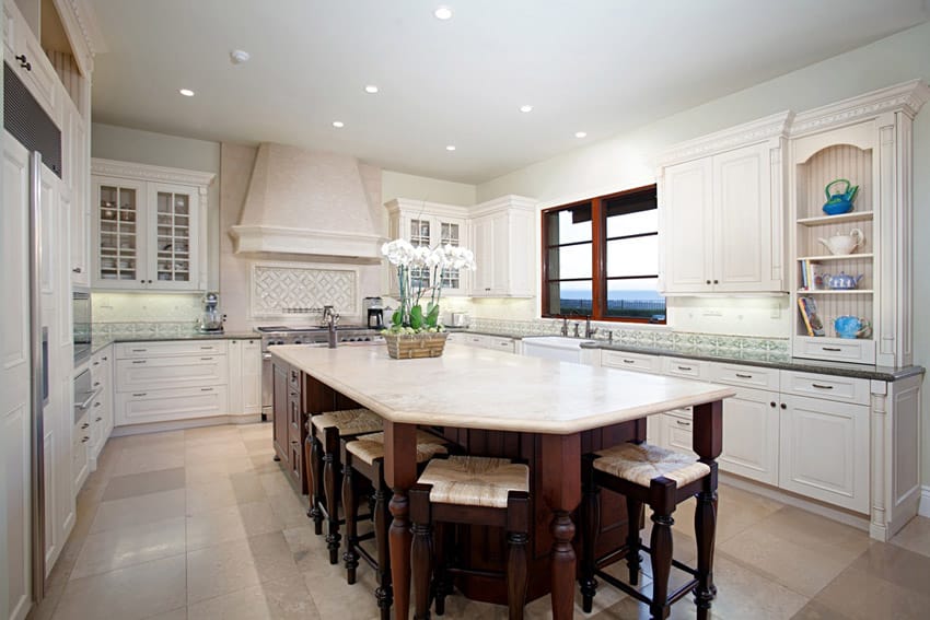 Beige colored island with dark cabinets and wooden legs