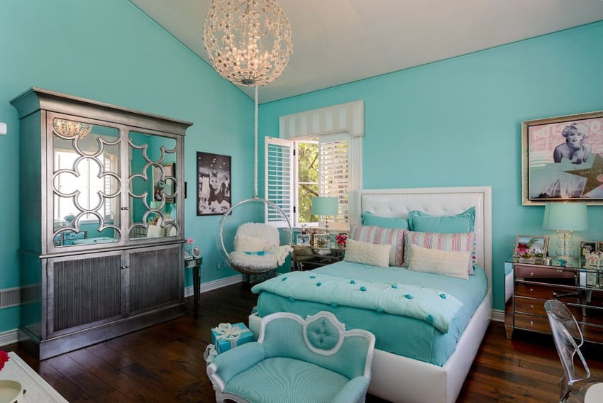 Luxury bedroom with round pendant and turquoise decor