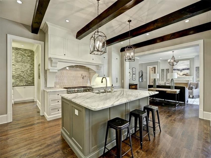 Kitchen with black bar stools and countertop with warm gray base