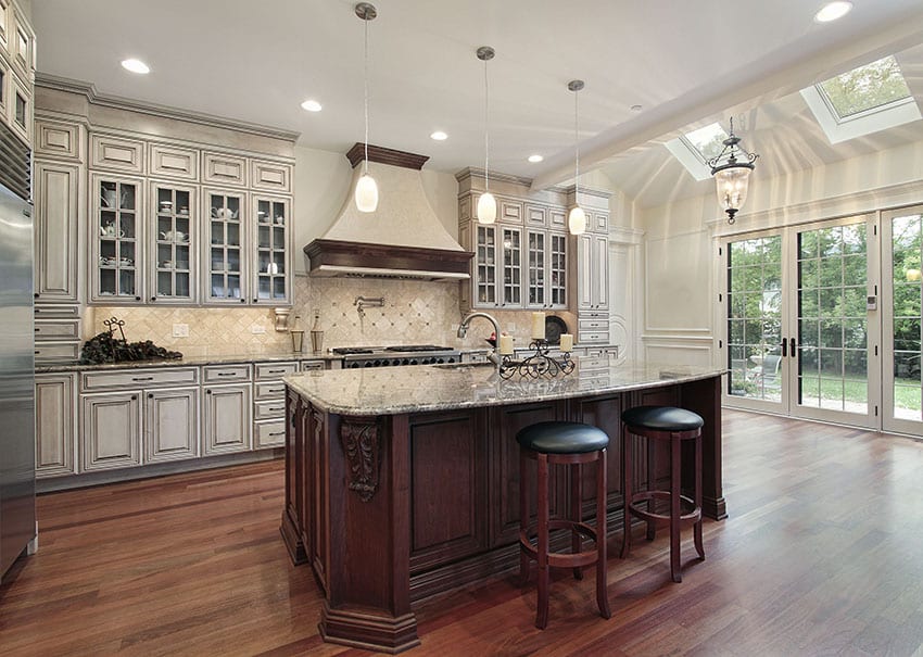 Luxury kitchen with white cabinetry and large cherry wood dining island