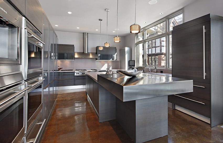 Modern kitchen with stainless steel counter and concrete flooring