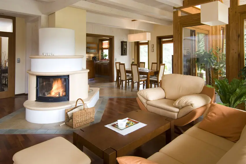 Spacious space with white fireplace and windows with teakwood frames