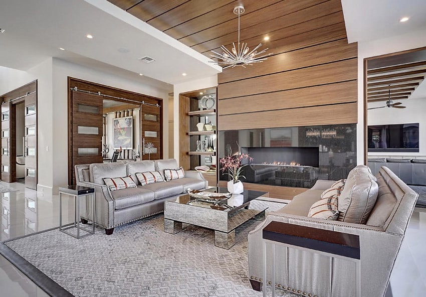 Room with interesting chandelier and wide indoor firepit