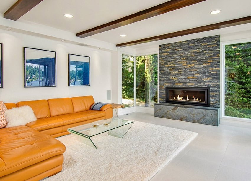 Modern living room with large fireplace and exposed wood beamed ceiling