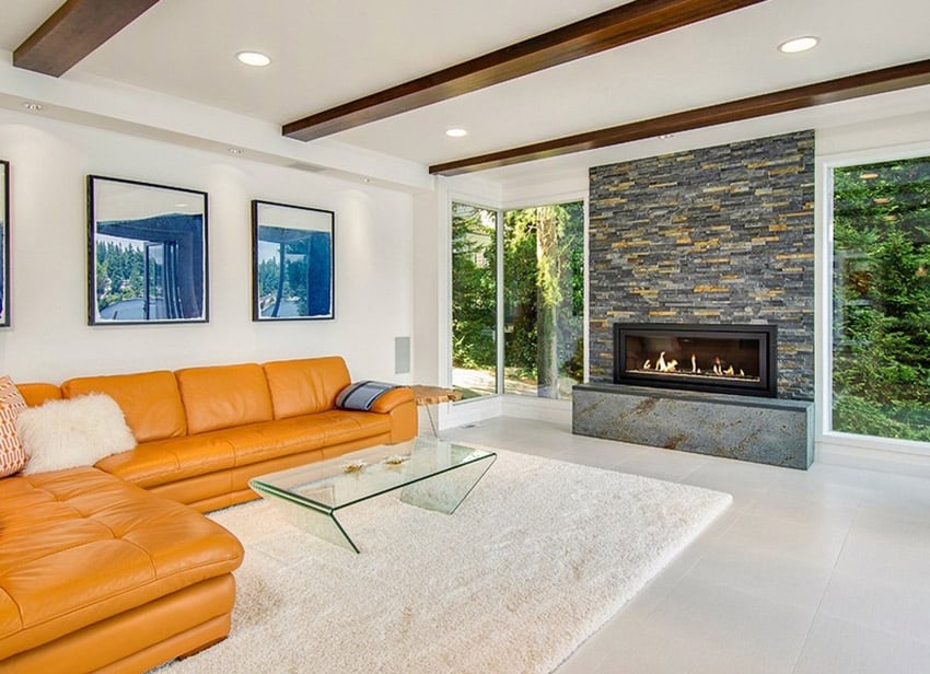 Room with slate fireplace and exposed wood beamed ceiling