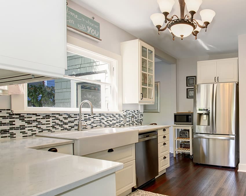 Small kitchen with quartz counters and white cabinets