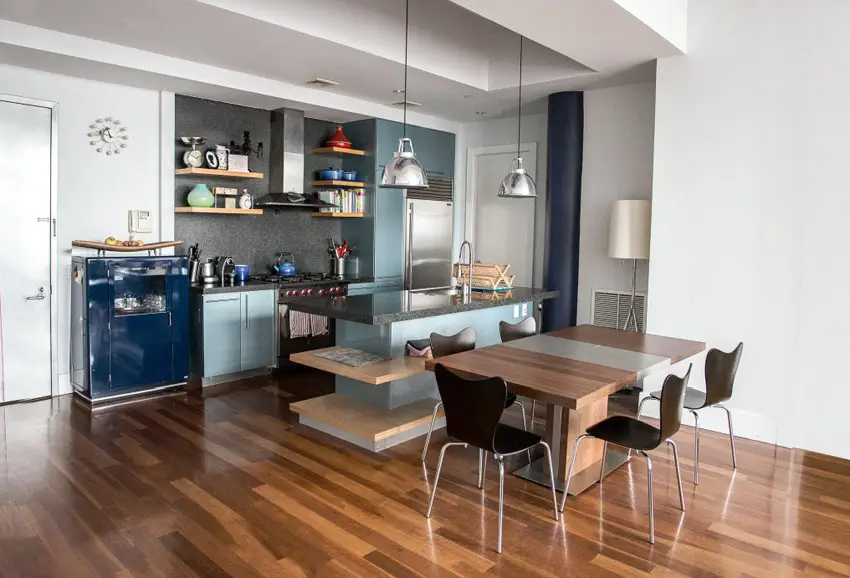 Kitchen with metallic blue cabinets and wood panel floors
