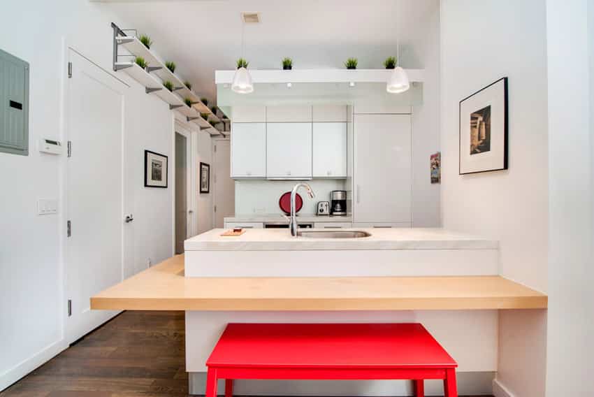 Kitchen with steel faucet, red bench and white door