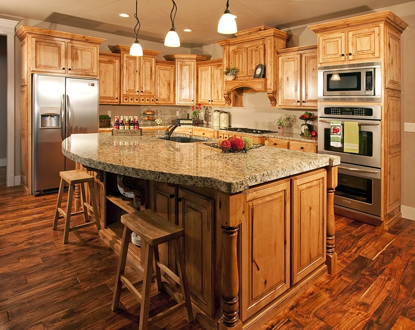 Thick granite topped kitchen island in wooden cabinet kitchen