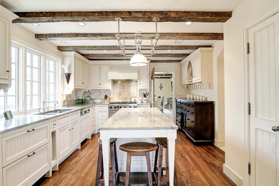 Traditional kitchen with center island exposed beams