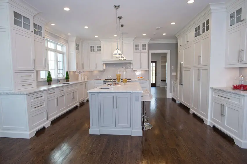Kitchen with pure all white color scheme and walnut flooring