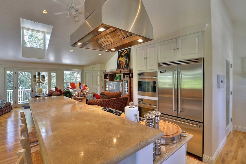 Kitchen with ceiling fan island and skylight