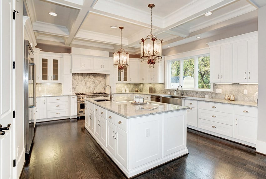 U shaped designed kitchen with cabinets painted in white