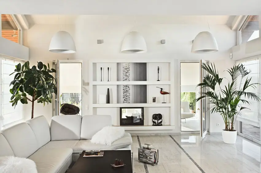Crisp white space with built-in shelves and wall lamps