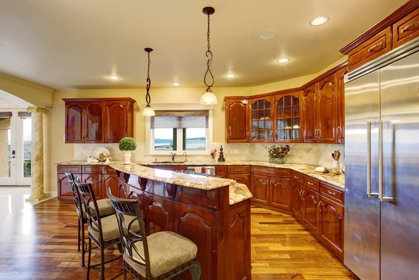 Bright traditional kitchen with polished wood floors and breakfast bar