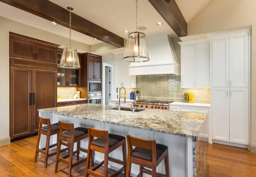 Kitchen with dining island, oak cabinets and glass tile backsplash