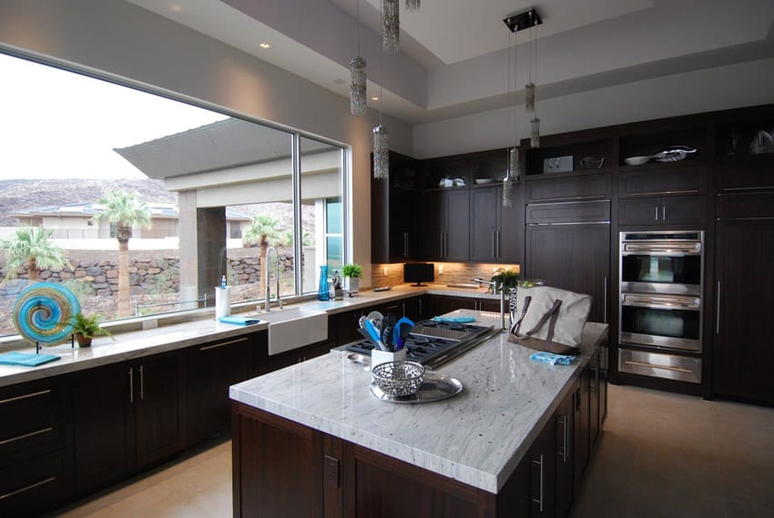 Kitchen with wooden cabinets and white marble counters