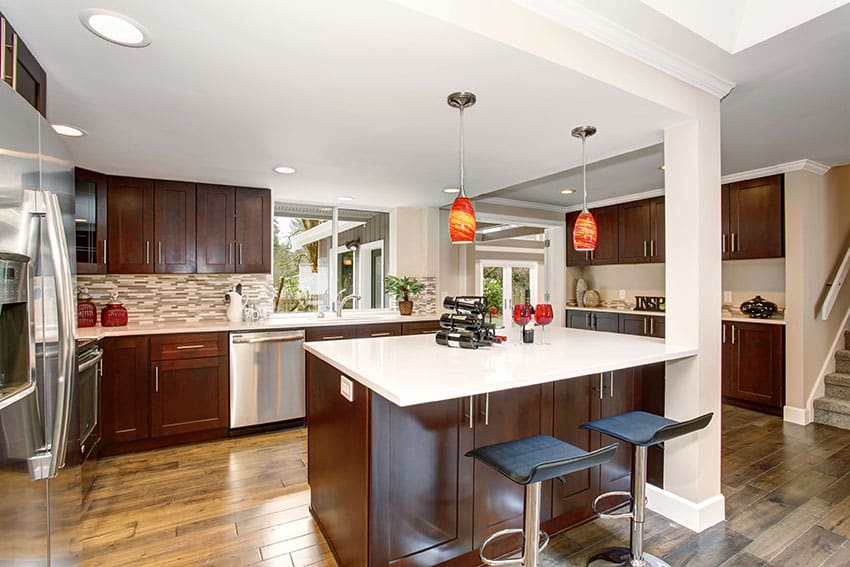 Contemporary kitchen with brown cabinets, glass backsplash and white quartz countertops