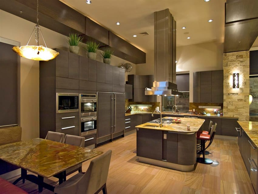 Kitchen with high ceilings, light wood floors and dark cabinets